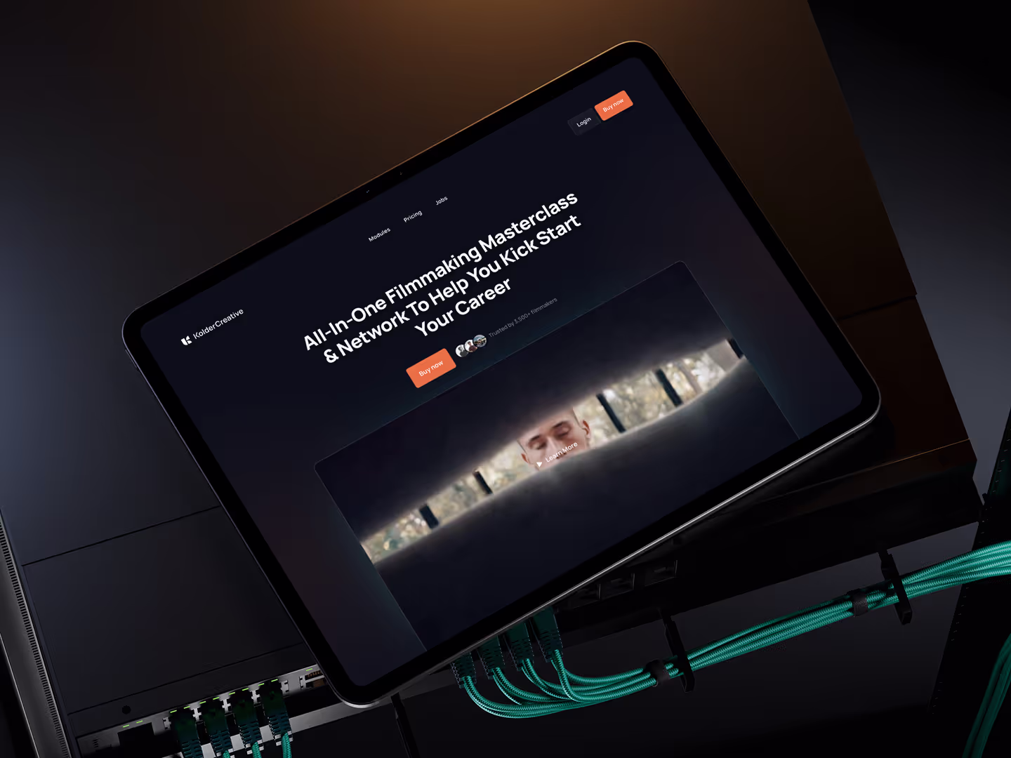 Dark cinematic webflow Website hero section design with orange and teal elements for Kolder Creative film school.